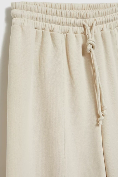 Spodnie dresowe z szerokimi nogawkami wiązane w talii beżowe