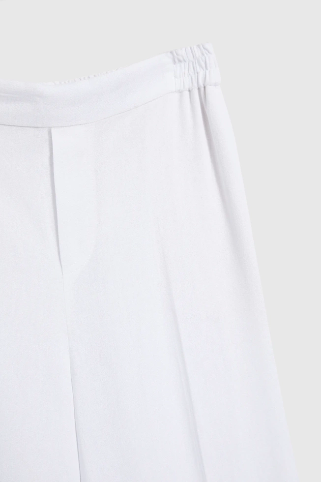 Lniane spodnie z nogawkami w kant białe