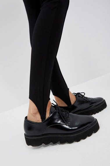 Gładkie spodnie z paskiem na stopie czarne