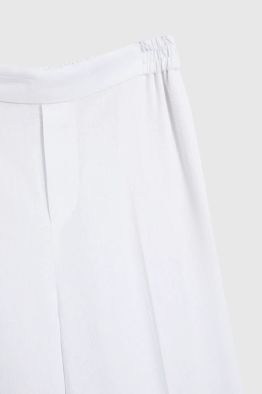 Lniane spodnie z nogawkami w kant białe